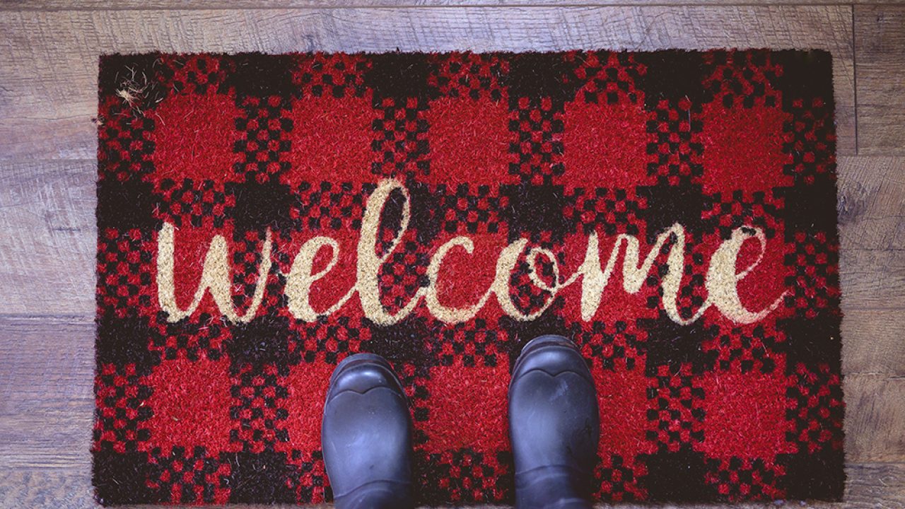 An overhead shot of a person standing on a welcome mat